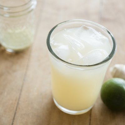Ginger ale with ice cubes in drinking glass