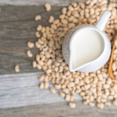 Soy milk and soy bean on wooden background