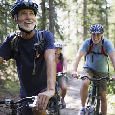 Man mountain biking in woods