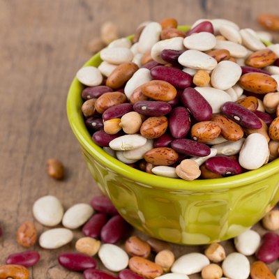 various beans on wooden surface