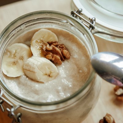 Classic homemade yogurt with slices of fruit. Banana with walnut. A wholesome morning breakfast.