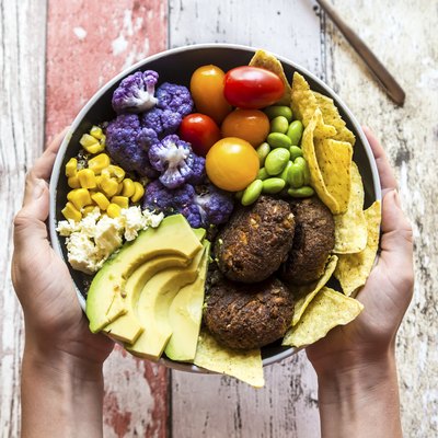 Holding choline-rich quinoa plant-based veggie bowl