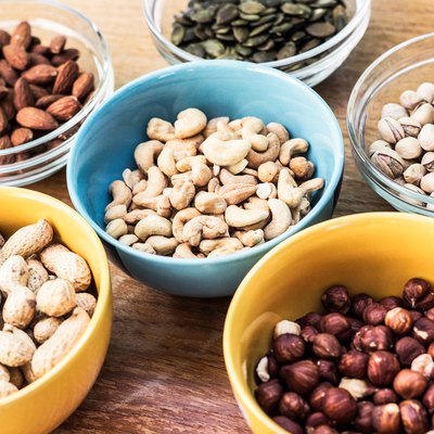 Assortment of mixed nuts on wood table background