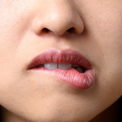 Midsection Of Woman Biting Lips