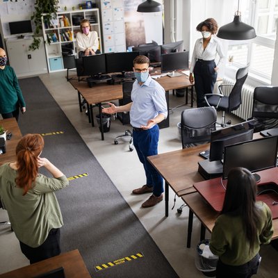 Staff meeting in office with social distancing
