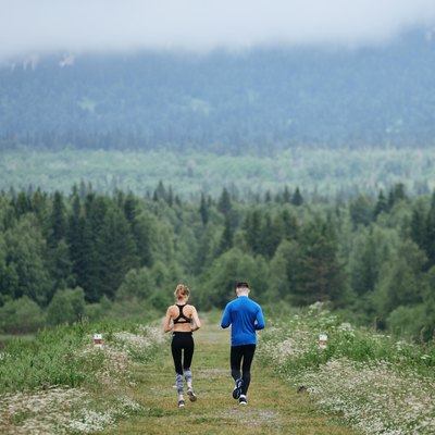 Man and woman running far away the wild road