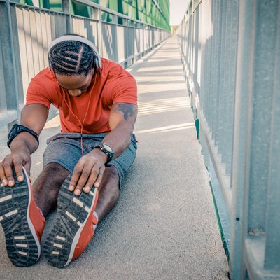 Fit young man stretching after exercising avoiding post-workout mistakes