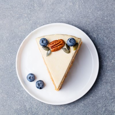 Vegan, raw carrot cake. Healthy food. Grey stone background. Top view.