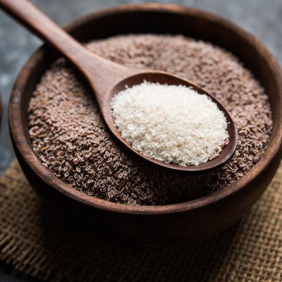 Psyllium husk or isabgol which is fiber derived from the seeds of Plantago ovata, mainly found in India. Served in a bowl over moody background. selective focus