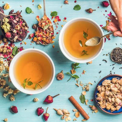 Two cups of healthy herbal tea with mint, cinnamon, dried