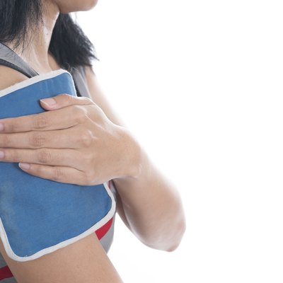 woman putting an ice pack on her shoulder pain