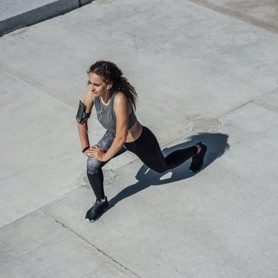 Young athletic woman stretching outdoors