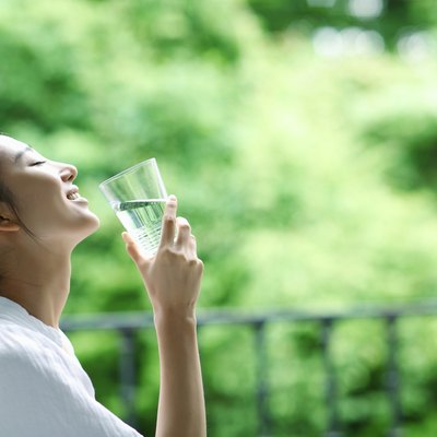 Young woman holding glass of water