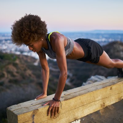 woman doing pushups on bench at runyon canyon after sunset