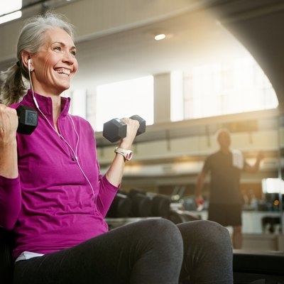 Menopausal woman doing strength training workout in the gym