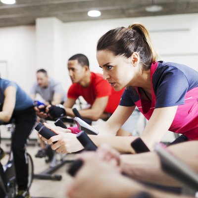 Group of people practicing sport in a gym.