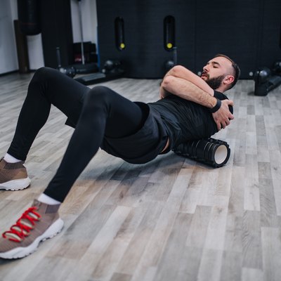 Exercising with foam roller in the gym
