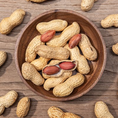 Peanuts in bowl on rustic wooden table