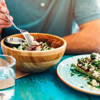 A man starting a vegan diet by eating a vegan meal at home