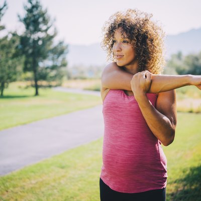 Pregnant woman exercising outside in a park