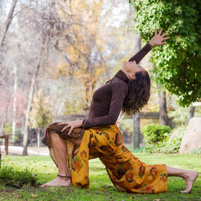 Woman practices yoga in the park