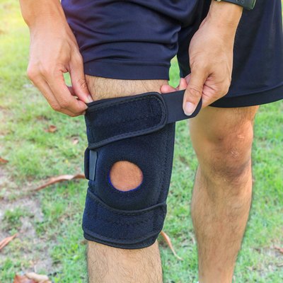 man wearing knee sleeve in the park
