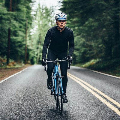 Person on a bike outdoors doing a HIIT cycling workout