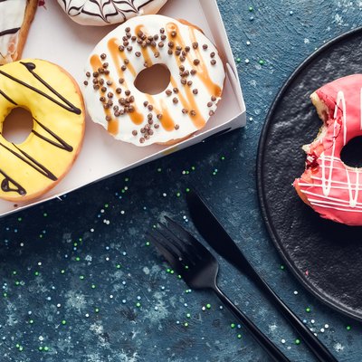 Pink frosted donut on dark background