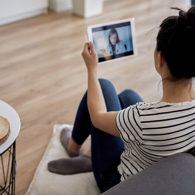 Young woman having a video conference with her doctor