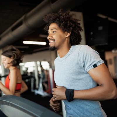Group of young people running on treadmills as part of their 5-day cardio workout plan