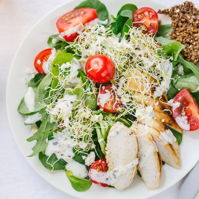 Top view of fresh summer salad on plate on table