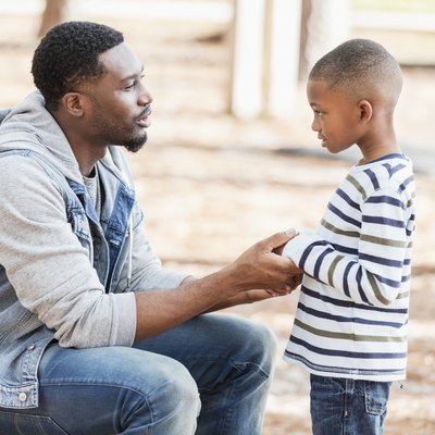 Father talking to son on playground