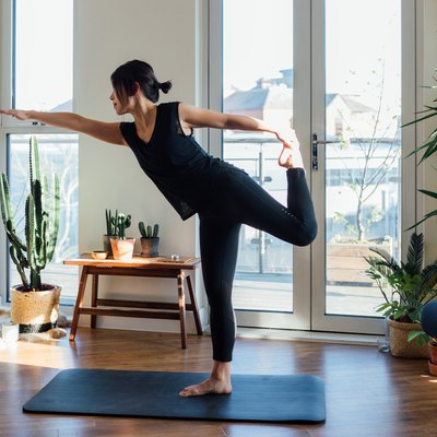 Young woman doing yoga exercise at home