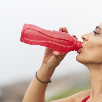 woman drinks water at training