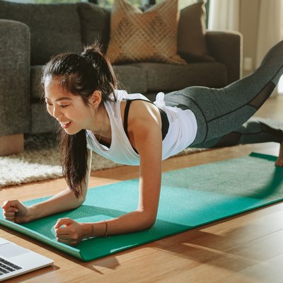A woman working out at home using the Beachbody program