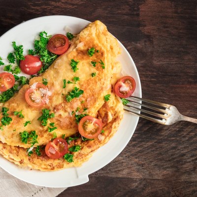 Omelette with parsley, cherry tomatoes, and copyspace