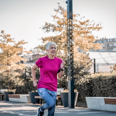 Woman jogging at average 5K pace outside