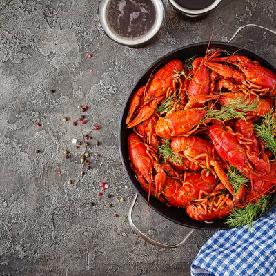Crayfish. Red boiled crawfishes on table in rustic style, closeup. Lobster closeup. Border design. Top view. Flat lay.