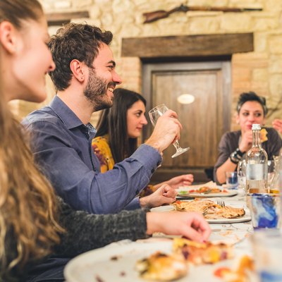 Friends eating pizza together and having fun