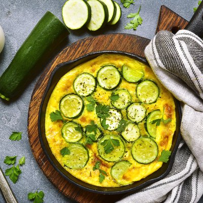 Oven baked omelette with zucchini in a cast iron pan