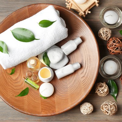 Spa composition with tea tree oil on wooden background