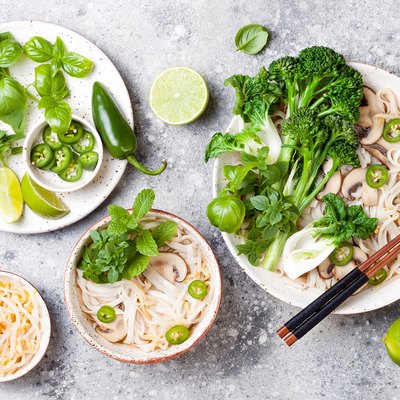 Vegetarian traditional Vietnamese soup Pho bo with herbs, rice noodles, broccolini, bok choy, bean sprouts, mushrooms. Vietnam national dish. Asian food concept.
