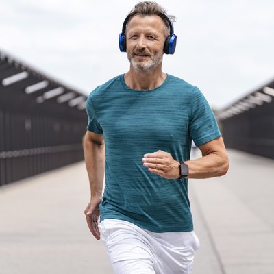 Sporty man wearing headphones and jogging