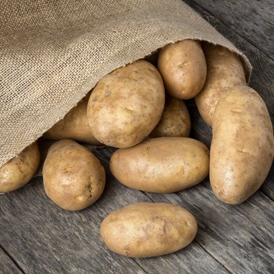 Russet Potatoes Spilling From Burlap Bag