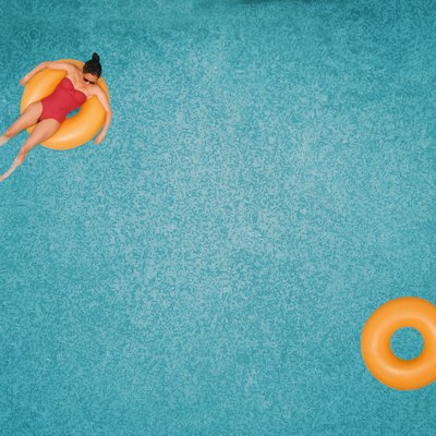 Carefree woman on ring in swimming pool