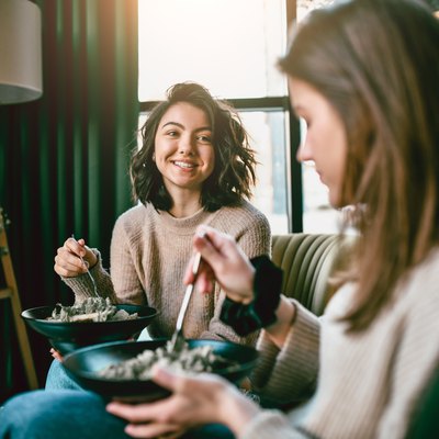 Two Cute Females Eating Salads Together