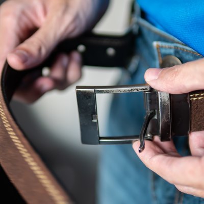 A man wearing leather belt with jeans