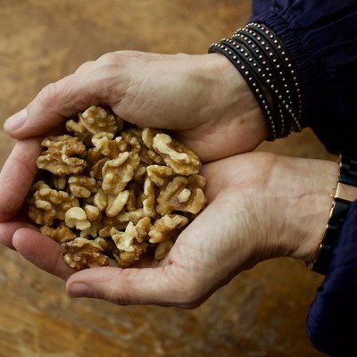 Hands holding walnuts