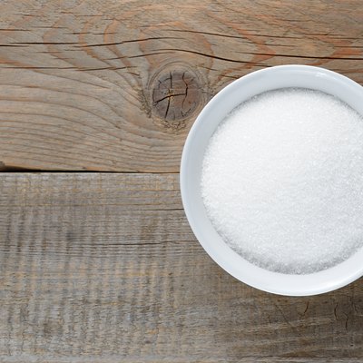 White sugar on wooden table