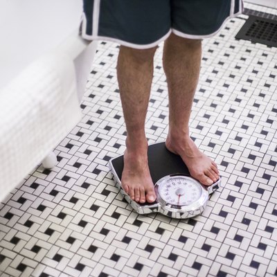 Adult man on bathroom scales.